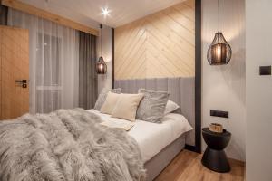 sypialnia z łóżkiem z futrzanym kocem w obiekcie Apartamenty u Zajączków w Zakopanem