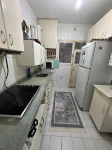 a kitchen with white appliances and white tile floors at Private Room in Istanbul #8 in Istanbul