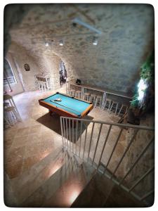 a pool table in a room with a stone wall at Le Vallaya Suites & Spa in Menton