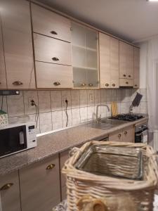 una cucina con lavandino e forno a microonde di Apartament Ana a Topliţa