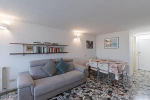 a living room with a couch and a table at [Duca d'Aosta - il soffio del mare] in Viareggio