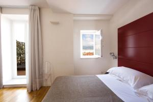 a bedroom with a large bed and a window at Hotel Piazza Bellini & Apartments in Naples