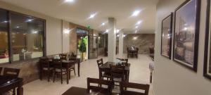 a dining room with tables and chairs in a restaurant at Black Iris Hotel in Madaba