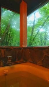 Oak Villa Nasu 抜群のプライベート空間 100インチ映像 轟音サウンド 人工芝デッキ في ناسو: نافذة في الحمام مطلة على الأشجار