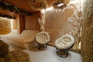 a sauna with two chairs in a room at Rest&Ski Spa Resort in Bukovel