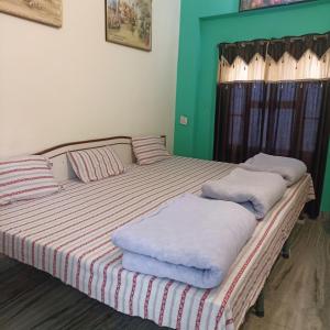 a bedroom with two beds with white pillows on them at Keshav Palace in Pushkar