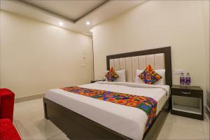 a bedroom with a large bed in a room at FabHotel AGK in Haridwār