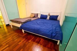 a bed with a teddy bear sitting on top of it at Elegant 5STAR Resort Suite Mid Valley KL Sunway by Stayz Suites with Shopping Complex in Kuala Lumpur