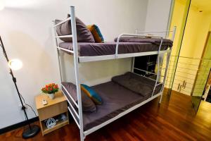 a couple of bunk beds in a room at Elegant 5STAR Resort Suite Mid Valley KL Sunway by Stayz Suites with Shopping Complex in Kuala Lumpur