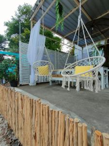 a porch with two chairs and a swing at I-Talay Zone Sea in Ko Samed