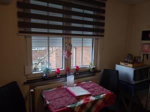 a table in a kitchen with a window at Ser's Studio Orange in Maastricht