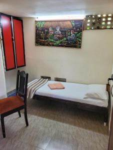 a small room with a bed and a chair at Bella Villa Luxury Stay in Panaji