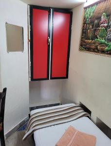 a small room with a bed and a window at Bella Villa Luxury Stay in Panaji