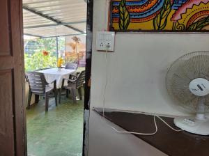 a fan on a wall next to a table at Bella Villa Luxury Stay in Panaji