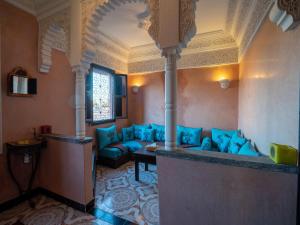 a living room with a blue couch in a room at Dar Ben Saleh in Marrakesh