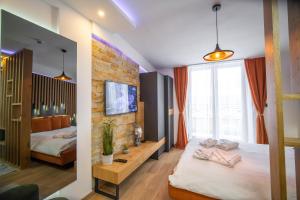 a bedroom with two beds and a brick wall at PleasureLUX MILMARI in Kopaonik