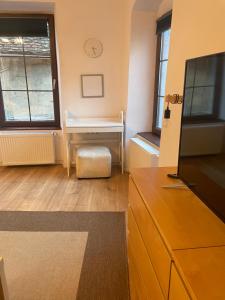 a living room with a tv and a desk at Central Retro Apartment in Sibiu