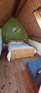 a bedroom with a wooden bed in a attic at Barèges Appartement vue montagne in Barèges