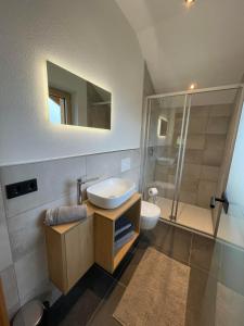 a bathroom with a sink and a toilet and a shower at Schneiderhof in Weerberg