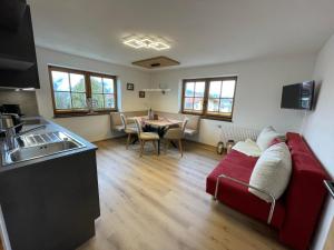 a kitchen and living room with a couch and a table at Schneiderhof in Weerberg