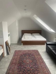 a bedroom with a bed and a rug on the floor at Apartment near Bonn/Cologne with nature access in Troisdorf