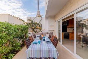 a dining table with chairs on a patio at Moradia Villa Brava - Algarve in Alvor