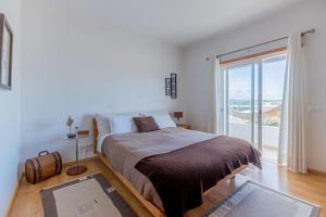 a bedroom with a large bed and a large window at Moradia Villa Brava - Algarve in Alvor +36 photos