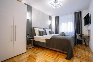 - une chambre avec un lit, un bureau et une fenêtre dans l'établissement Apartments Hana City Center, à Livno