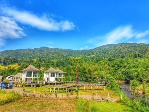 a house with a view of a river and mountains at Vieng Sava in Ban Huai Ti