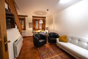 a living room with a couch and chairs and a table at Cala Pepita in Alpens