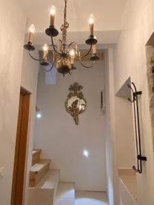 a chandelier hanging in a hallway with stairs at Guesthouse Riba in Vrsar