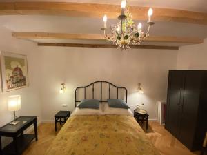a bedroom with a bed and a chandelier at Guesthouse Riba in Vrsar