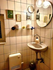 a bathroom with a sink and a mirror at Ferienhaus Dhrontal in Neumagen-Dhron