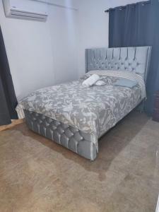 a bed in a room with a gray bed frame at Samana house in Santa Bárbara de Samaná