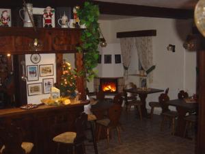 a living room with a christmas tree and a fireplace at Gaststätte & Pension Alte Mühle in Dorfchemnitz