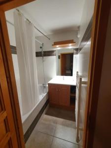 a bathroom with a shower and a sink and a tub at Chalet de la Grand Vy : Appart 6/7 personnes. in Valloire