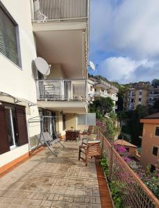 a balcony of a building with chairs and a table at Bedrock in Salerno