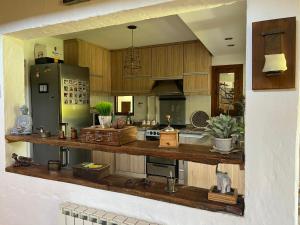a kitchen with wooden cabinets and a green refrigerator at Casa H6 in Maipú