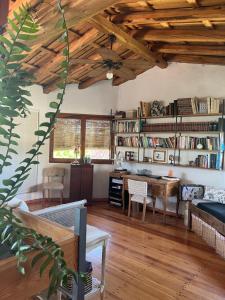 a living room with a table and a desk at Casa H6 in Maipú