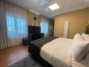 Postel nebo postele na pokoji v ubytování Badam d'Art Boutique Hotel