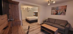 a living room with a couch and a bed at Hotel Geiger in Füssen