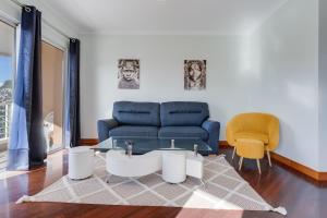 a living room with a couch and a glass table at Camara de Lobos Duplex Apartment by Holiday Rental Madeira in Câmara de Lobos