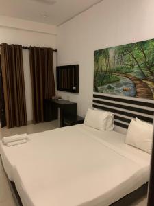 Postel nebo postele na pokoji v ubytování Sunrise Palace Negombo