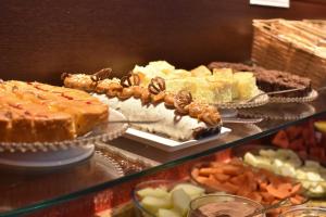 a buffet of different types of cakes and other desserts at Sandri City Hotel in Balneário Camboriú