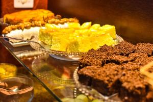 a buffet of desserts on a glass table at Sandri City Hotel in Balneário Camboriú