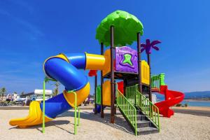 a playground with a slide on the beach at Mobile Homes in Camping Omisalj, island Krk, with swimmingpool in Omišalj