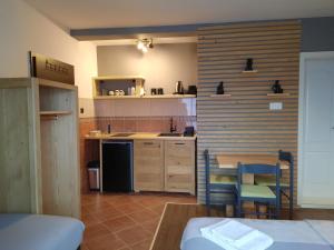 a kitchen with a table and chairs in a room at Mrdja Apartments in Kolašin