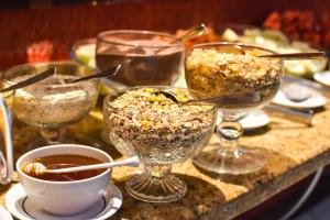 a table topped with glasses of food and a bowl of popcorn at Sandri City Hotel in Balneário Camboriú