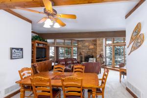 a dining room with a table and chairs and a ceiling fan at Powder Run B-21 in Park City