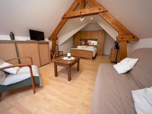 a attic room with a bed and a table at Chambre D'hôtes Francine et Gérard in Le Mans